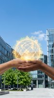 Hand holding glowing globe with world landmarks and network connections above urban cityscape, representing global business, sustainability, and international commerce opportunities.