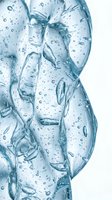 Clear water with bubbles and flowing streams on white background, suitable for skincare, cosmetics, wellness and beverage product packaging design.