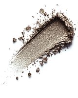 Crushed brown eyeshadow powder smear with scattered particles on white background for cosmetic and beauty product design applications.