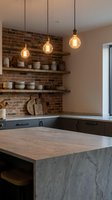 Modern industrial kitchen interior with exposed brick wall, pendant lighting and marble island for contemporary home design and renovation projects.