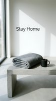 Minimalist cozy home interior with folded gray blanket and black coffee mug on concrete bench, natural light, stay home concept.