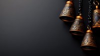 Ornate copper bells with intricate patterns hanging on chains against dark background for traditional ceremonies and cultural celebrations.