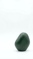 Green jade egg stone isolated on white background for wellness meditation and spiritual healing practices.