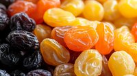 Colorful assortment of dried fruits including dates, apricots, raisins and golden sultanas arranged together for healthy snacking and cooking ingredients.
