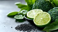 Fresh lime slices and broccoli florets arranged with black sesame seeds on gray surface for culinary and healthy eating content.