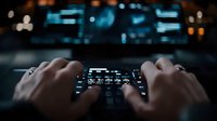 Hands typing on laptop keyboard at night with blurred city lights in background. Dark workspace atmosphere for technology and business concepts.