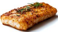 Pan-seared cod fillet with crispy golden crust, fresh rosemary garnish on white background, close-up view showing flaky texture and caramelized surface.