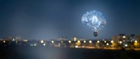 Glowing brain lightbulb floating above blurred city lights at night representing innovation, creativity, artificial intelligence and bright ideas for business.