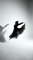 Graceful female dancer in flowing black dress captured mid-leap against white studio background with dramatic shadow, expressing freedom and artistic movement.