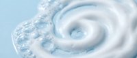 Swirling water vortex with bubbles creating dynamic spiral motion in clear liquid. Natural fluid dynamics and turbulence patterns for science concepts.