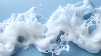 Swirling white soap foam with bubbles on light blue background creates dynamic texture pattern for cleaning and hygiene concepts.