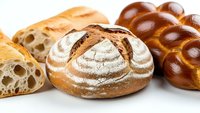 Artisan bread collection featuring sourdough, challah and rustic loaves on white background. Fresh bakery products for culinary and food photography.