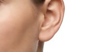 Close-up of human ear showing detailed anatomy and skin texture for medical education and healthcare concepts.