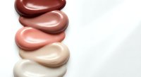 Cosmetic foundation makeup samples in various skin tone shades from light to dark arranged on white background for beauty and skincare applications.
