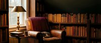 Cozy reading corner with vintage leather armchair and extensive book collection in warm home library setting for relaxation and literary pursuits.