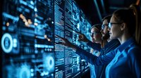Professional team analyzing digital data visualization on transparent screens in modern control room, illuminated by blue technology interface displays.