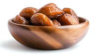Sweet dried dates in wooden bowl isolated on white background, nutritious Middle Eastern fruit snack popular during Ramadan.