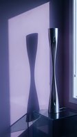 Modern metallic vase with twisted design casting dramatic shadow on pink wall, contemporary home decor and interior styling.