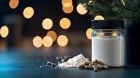 White protein powder and supplement capsules with glass jar on dark background with golden bokeh lights and pine branches, fitness nutrition concept.