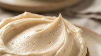 Creamy peanut butter swirl with smooth texture and glossy finish, ready for food styling, culinary content, and recipe illustrations.