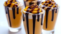 Layered caramel coffee dessert with chocolate drizzle and whipped cream in glass cups for cafe menu, beverage photography, food styling projects.