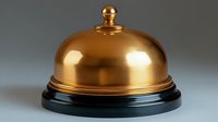Service bell with golden dome on black base against gray background, luxury hotel and restaurant concept for hospitality industry and customer service.
