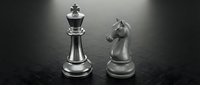 Silver metallic chess pieces king and knight on dark textured surface representing strategy, leadership and tactical thinking in business competition.