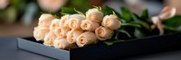 Elegant peach roses bouquet in black gift box for romantic occasions, weddings, anniversaries and special celebrations with soft natural lighting.