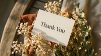 Thank you card nestled among dried wildflowers and rustic wooden decor, warm tones, elegant serif font, gratitude and appreciation concept.