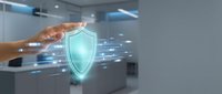 Hand touching holographic shield icon with digital data streams in modern office environment representing cybersecurity protection and network safety solutions.