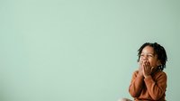 Young child with dark curly hair and medium skin tone sitting against mint green background, hand to face in thoughtful or worried expression, wearing brown long-sleeved shirt, suitable for parenting, child development, and emotional education content.