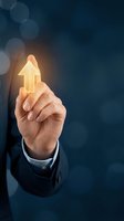 Businessman holding glowing upward arrow symbol representing growth, success, and positive business direction. Concept for corporate advancement and financial improvement.