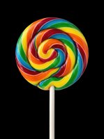 Colorful spiral lollipop with rainbow swirls isolated on transparent background, ready for t-shirt designs, clipart, stickers, and print-on-demand products.