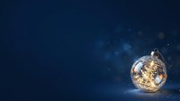 Transparent glass ornament filled with warm golden lights and glowing particles on deep blue background, isolated for holiday designs and festive compositions.