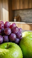 Fresh green apples and purple grapes with water droplets on a kitchen counter, showcasing healthy eating and organic produce.