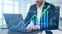 Professional businessman analyzing financial growth data on laptop with digital charts and upward trending arrows overlay in modern office environment.