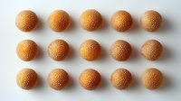 Fresh orange citrus arranged in neat rows on white background, showing vibrant textured peel pattern and natural organic shapes. Minimalist food composition.