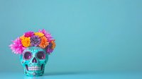 Turquoise decorative skull with vibrant pink and orange flower crown against blue background, Day of the Dead style celebration art with copy space.