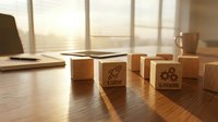 Wooden blocks with business icons on office desk representing startup growth, teamwork and innovation concepts for corporate strategy planning.