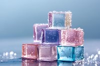 Colorful frozen ice cubes with water droplets stacked in pyramid formation on wet surface for beverage cooling and refreshment concepts.