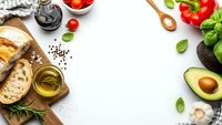 Fresh ingredients frame with bread, avocado, tomatoes, olive oil and herbs on white background. Cooking and healthy eating concept for recipes.