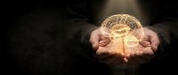 Hands holding glowing brain with neural networks representing artificial intelligence, mental health, psychology, neuroscience and cognitive thinking concepts.