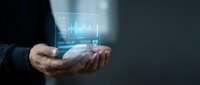 Businessman holding glowing holographic display with financial charts and data analytics for digital technology and investment concepts.