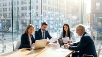 Diverse business team collaborating in modern office with city skyline view, reviewing documents and laptop during corporate meeting for teamwork and professional communication.