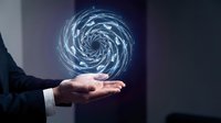 Businessman holding glowing spiral vortex of light energy in palm, representing innovation, technology, and digital transformation for business concepts.