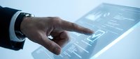 Businessman hand touching digital tablet screen with financial data charts and graphs for business analytics and market research applications.