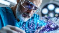 Senior Caucasian male scientist with gray beard wearing protective glasses examines glowing neural network hologram in modern laboratory setting.