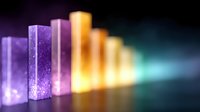 Colorful glowing rectangular blocks arranged in ascending order creating gradient from purple to orange and turquoise, on dark background with light effects.