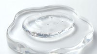 Transparent gel or serum droplet with fluid texture on white background, isolated for skincare, cosmetics, and beauty product design applications.