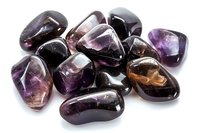 Collection of polished purple amethyst gemstones with natural color variations isolated on white background for jewelry and crystal healing designs.